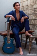 Man in Beach Side Pair Navy Blue linen suit with double-breasted jacket and loose-fitting trousers, casual and stylish look