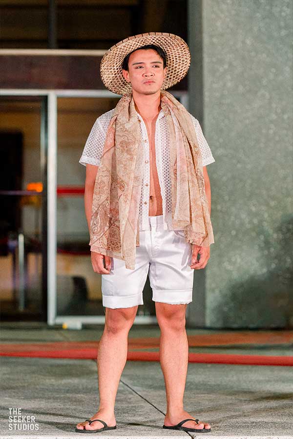Model in a casual ensemble with open weave shirt and patterned scarf at the Philippine fashion show by Tingting Delfin