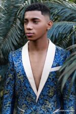 Close-up of a man in a Royal Blue brocade blazer with intricate gold patterns and cream lapel