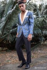 Man in a Royal Blue brocade blazer with gold detailing and cream lapel, paired with black formal trousers