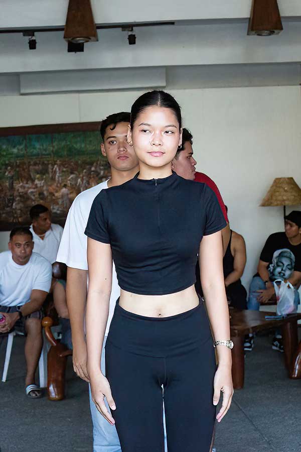 Models lined up practicing their runway walk during rehearsals before the fashion show in Dumaguete