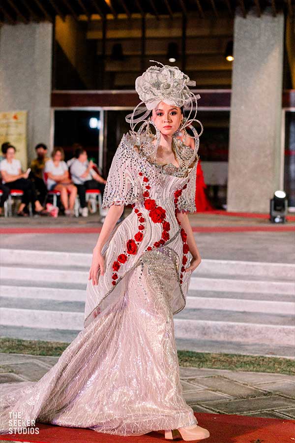 Model in a gown with red floral details and silver embellishments at the Philippines Fashion Show