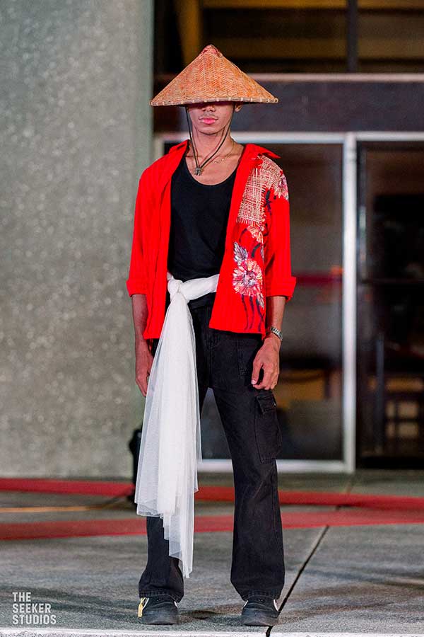 Model in a red embroidered top with a bamboo hat at the Philippine fashion show