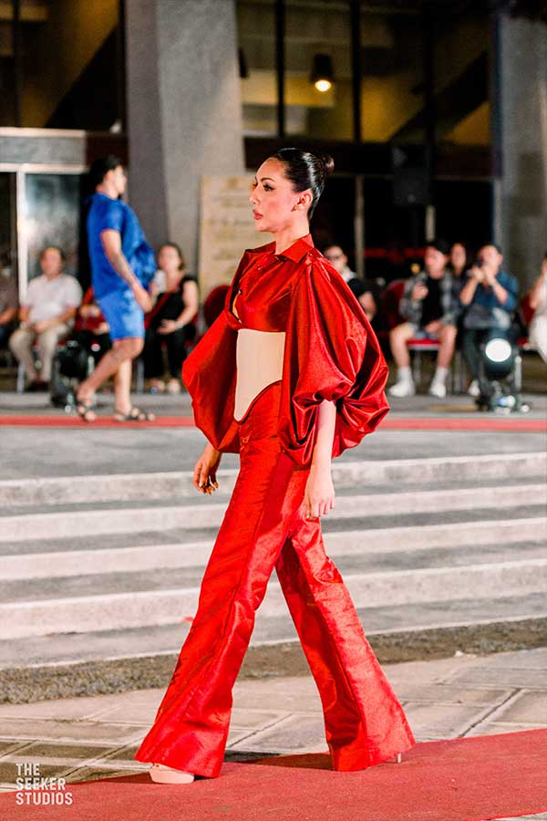 model in a red ensemble with Barong Jusi corset walking on the runway at Silliman University in the Philippines