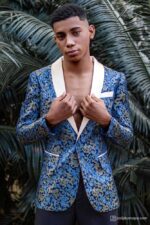 Man wearing Royal Blue brocade blazer with intricate gold patterns and cream lapel, elegant formal look