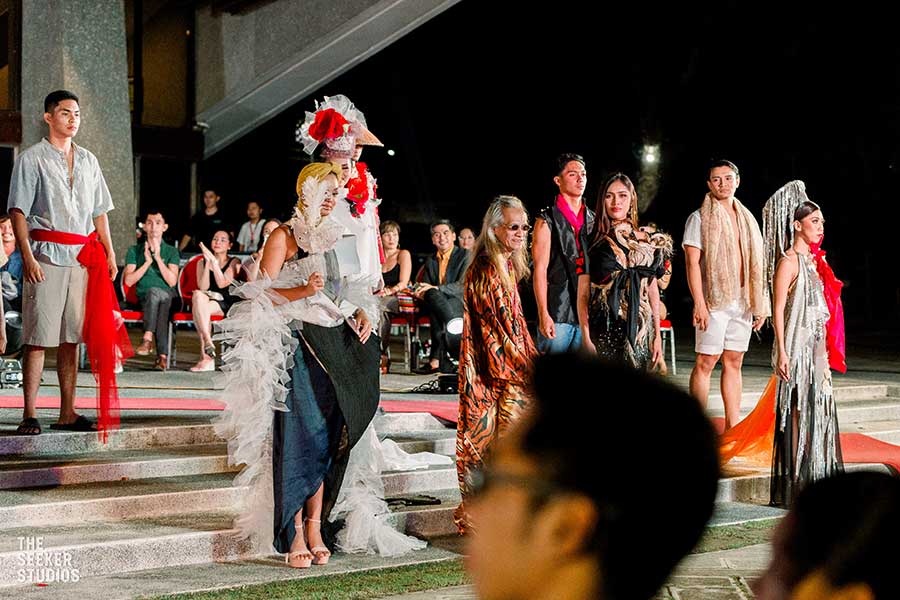 Tingting Delfin with models presenting his designs at a fashion event