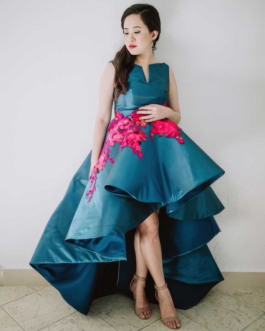 Custom-designed blue layered gown with bold pink floral accents – a statement in bespoke tailoring