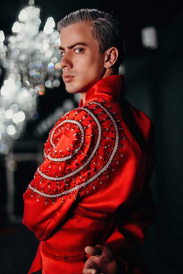 Red evening jacket with circular bead embroidery arranged in concentric patterns on the shoulder, close detail