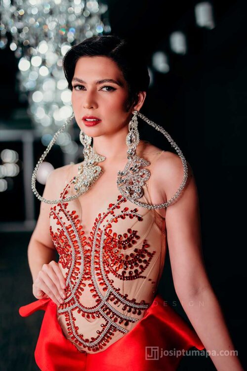 Beaded bodice of red evening dress on sheer mesh base