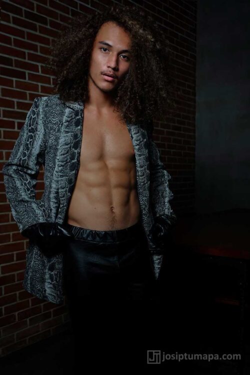 Modern evening menswear jacket worn open; black gloves, defined waist line, and an elongated front opening