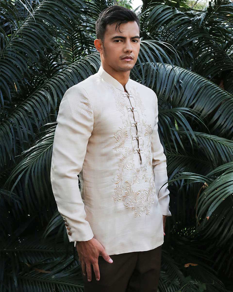 Man in cream Classic Barong with embroidery, standing among tropical plants, ideal for Filipino weddings
