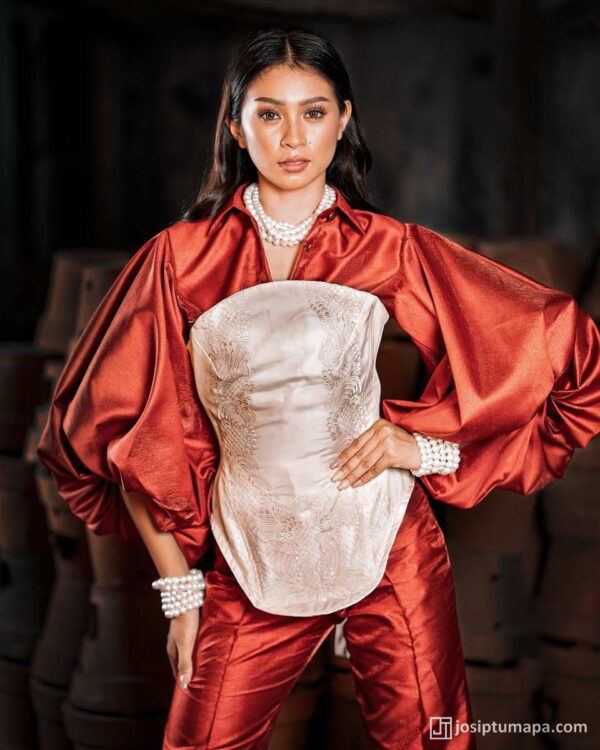 Red silk ensemble with embroidered cocoon corset and dramatic sleeves