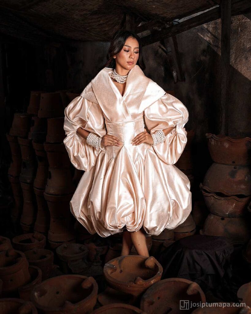 Sculptural Modern Filipiniana dress in pearl ivory with voluminous layered silhouette and refined fabric folds highlighting contemporary form