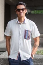 Man in casual white shirt with ethnic woven pocket and patterned inner collar