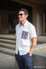 Close-up of short-sleeve shirt with colorful pocket and woven hem accent