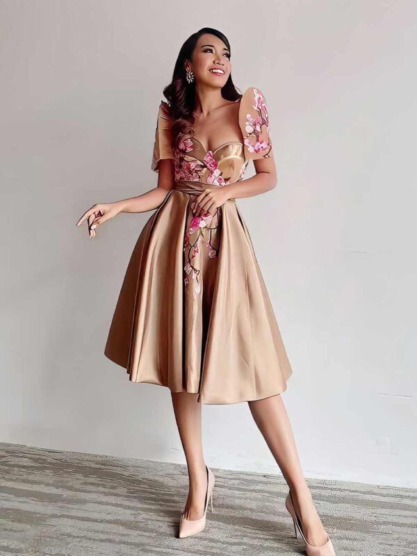 Modern Filipiniana dress with butterfly sleeves and floral embroidery showing today’s Filipino fashion direction