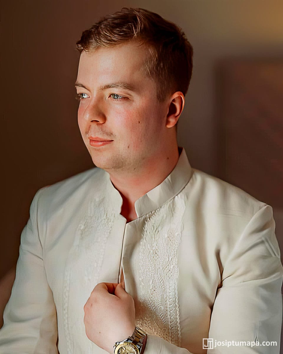 Groom adjusting his custom Coat Barong before the wedding ceremony