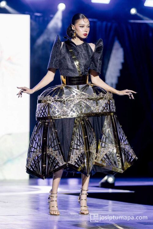 Contemporary Filipiniana terno with black textile base and gold geometric cage skirt structure