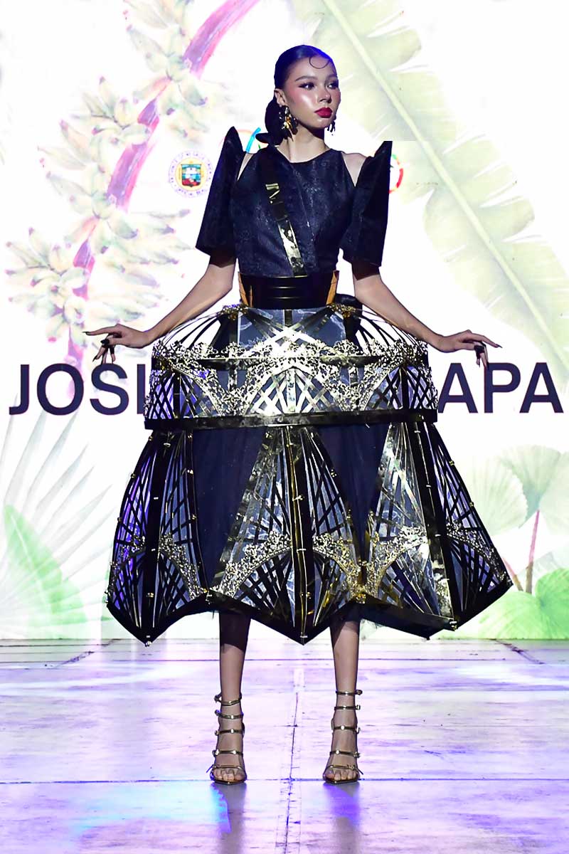 Filipiniana terno with gold framework skirt and modern black bodice presented on runway
