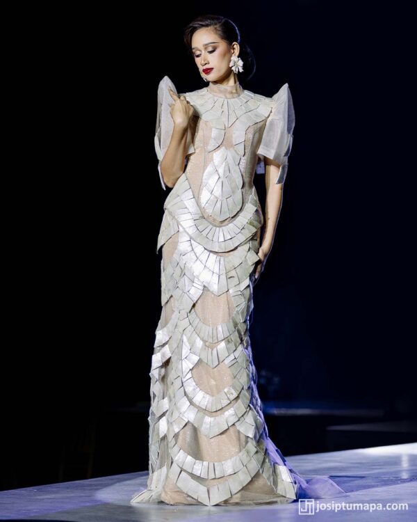 Modern Filipiniana dress presented on the runway, with articulated surface layers following a disciplined vertical structure