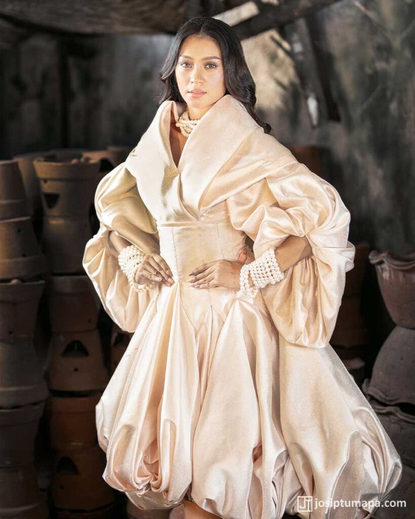 Modern Filipiniana dress in pearl ivory with rounded volume, layered folds, and soft gathered sleeves