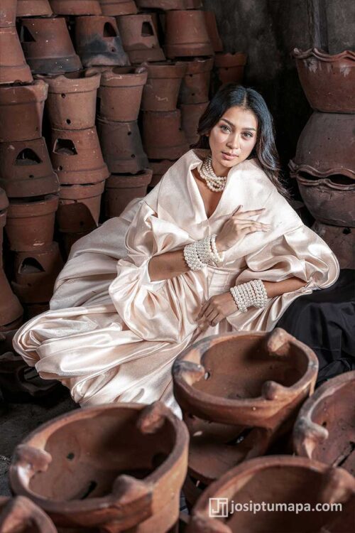 Close view of a Maria Clara gown featuring a sculpted panuelo, pearl-detailed cuffs, and soft champagne satin texture