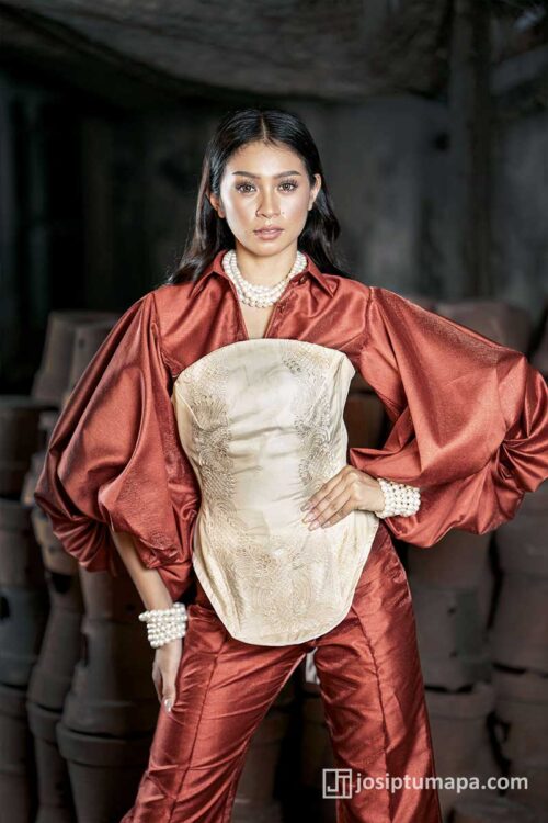 Scarlet terno ensemble in deep red tones with a piña cocoon silk corset, defined waistline, pearl accents, and wide sculptural sleeves
