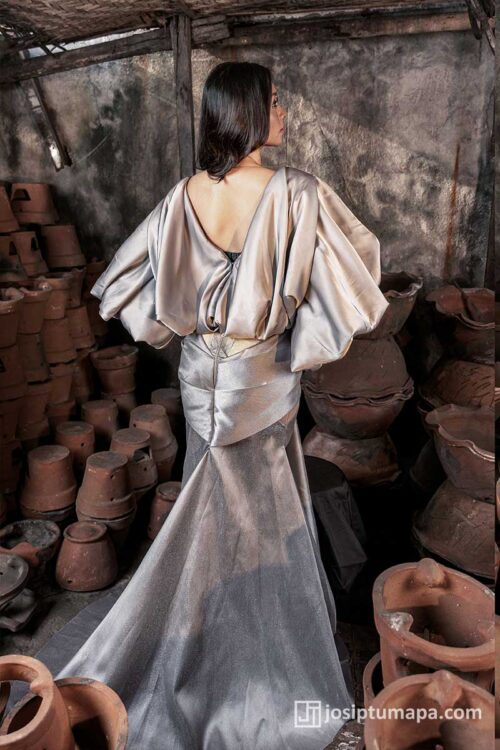 Silver Filipiniana gown with open back, voluminous sleeves, defined waist, and long flowing train