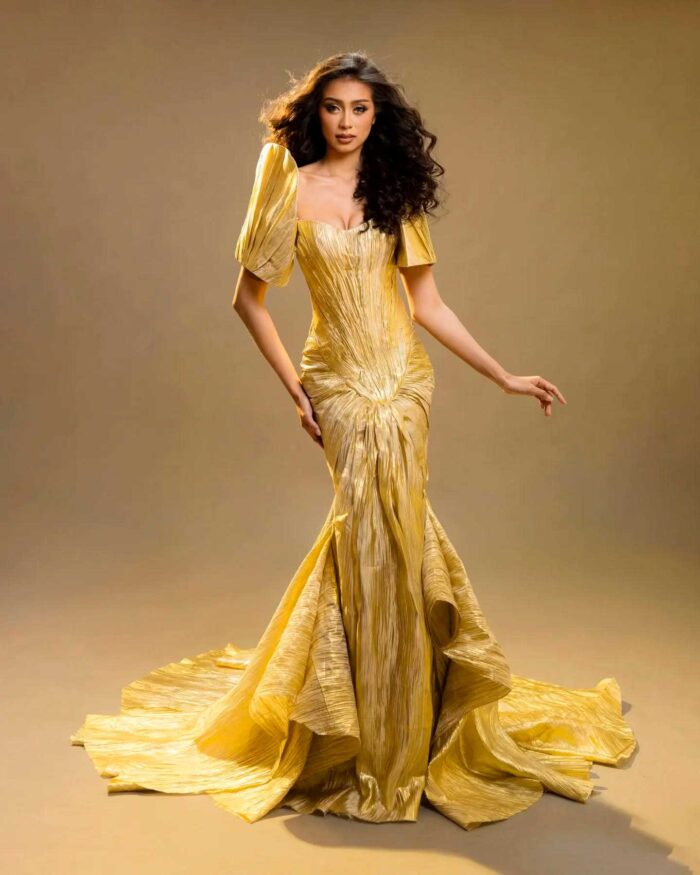 Modern Filipiniana gown with terno-inspired sleeve and wide train in full-length studio portrait