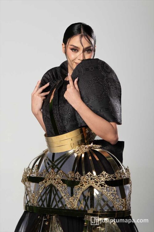 Contemporary Filipiniana terno with black butterfly sleeves, metallic cage skirt, and Kuna-inspired moving lower form