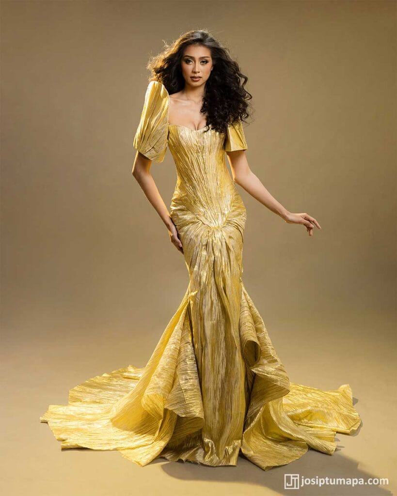Gold Filipiniana evening gown with butterfly sleeves and long fitted skirt