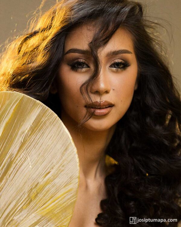 Portrait of Miss Universe Philippines contestant in gold Filipiniana gown