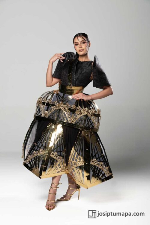 Modern Filipiniana terno with black sleeves, metal waist bands, and geometric skirt panels that shift with movement