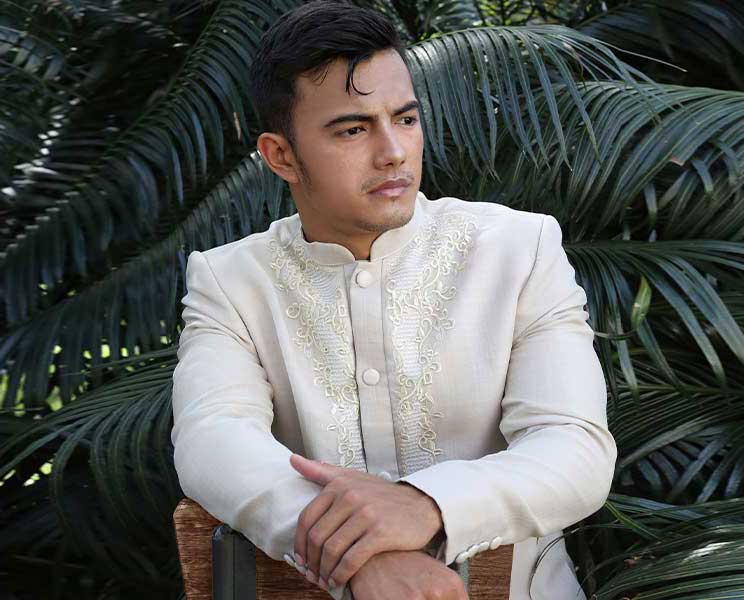 Man in Elegant-Coat Barong Posing in Tropical Setting