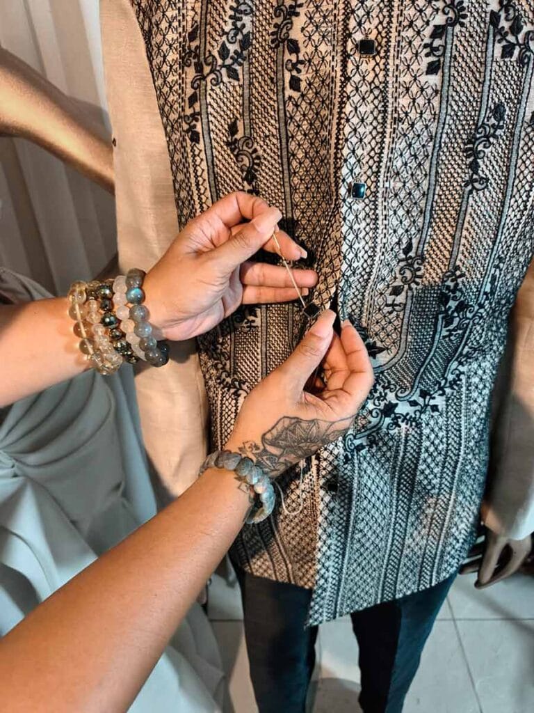 Josip making final adjustments to a custom Barong Tagalog