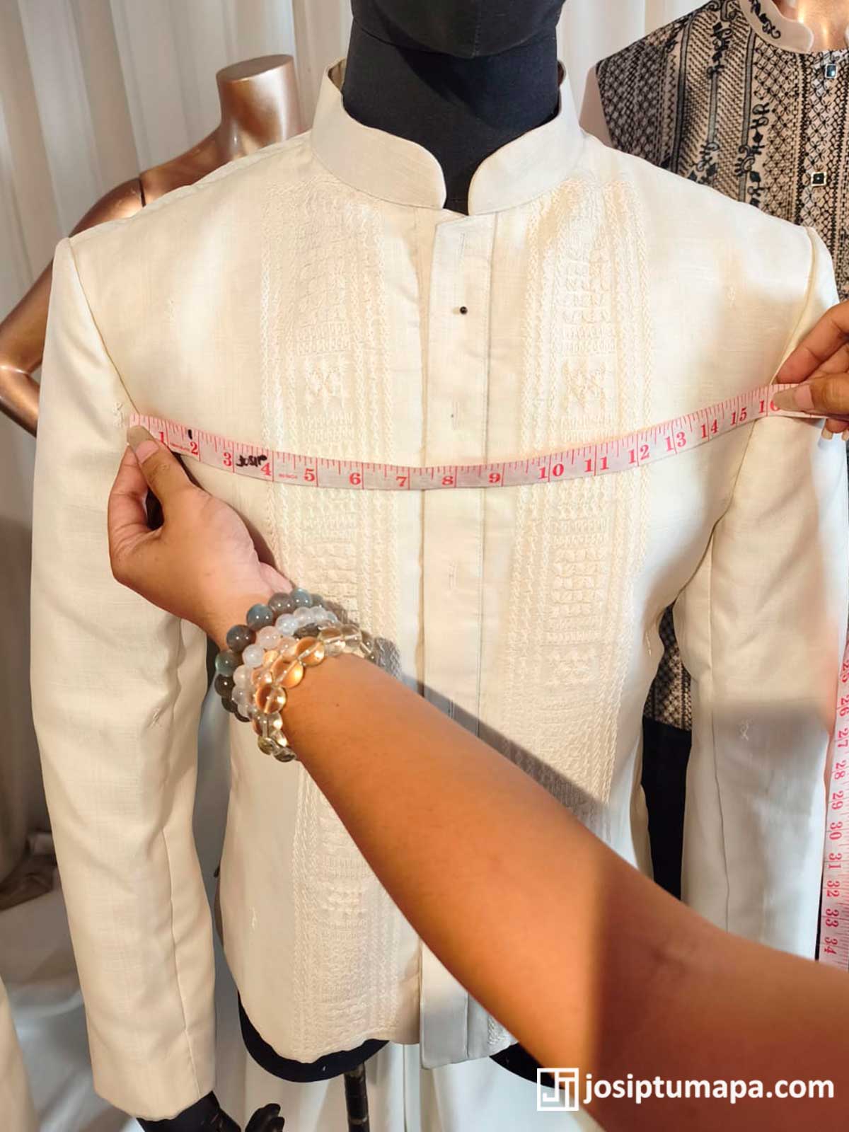 Measuring a custom Barong Tagalog across the chest during fitting