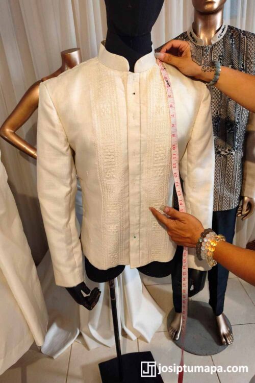 Coat Barong Fitting and Measurement in the Studio Cream coat-style Barong Tagalog on a mannequin during fitting and measurement in the design studio