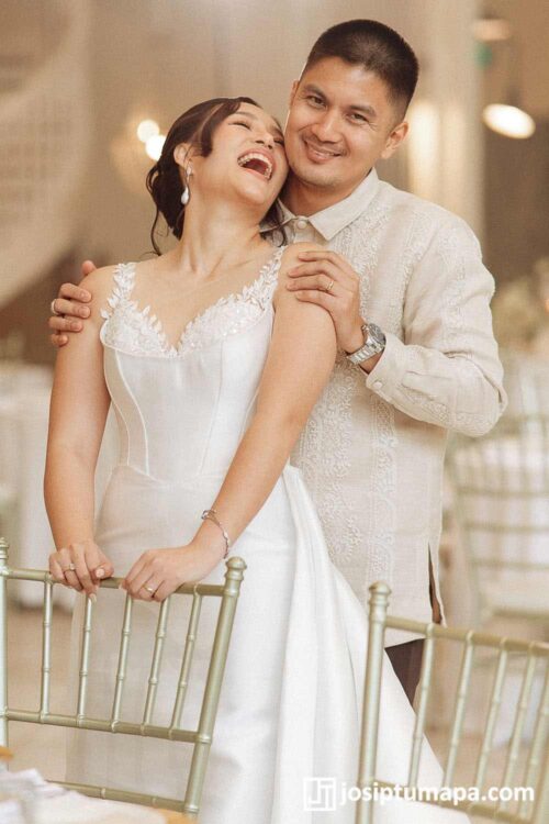 Wedding Barong Tagalog with a Modern Bridal Look Groom in an embroidered Barong Tagalog standing with a bride in a modern white wedding dress